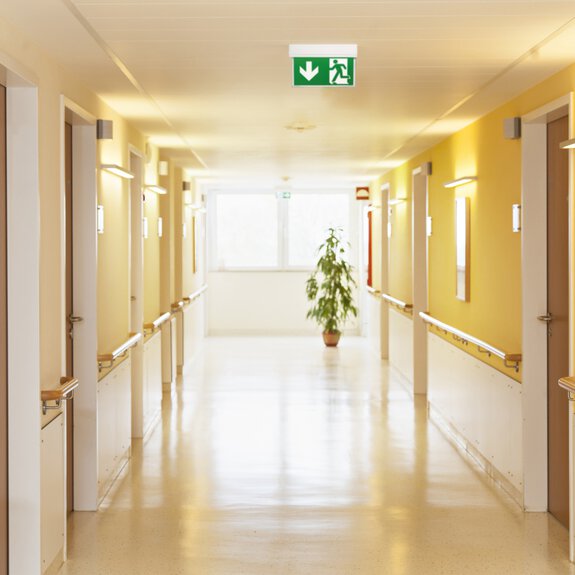 Interior view of a corridor in a hospital with an emergency light 